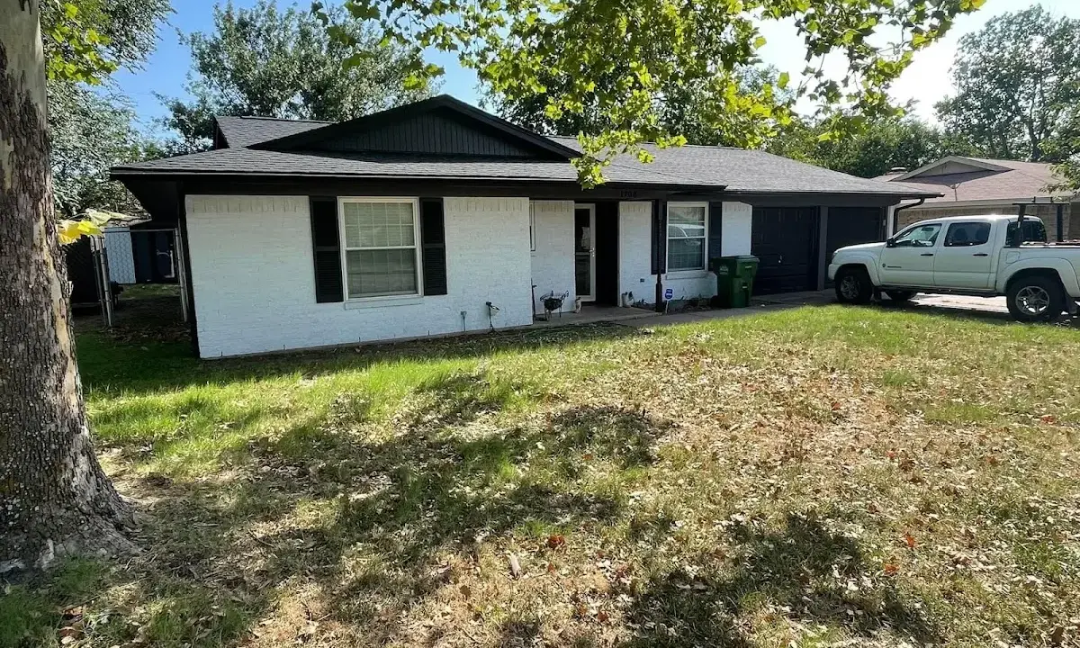 Professional roofing crew working on a residential roof in Tremonton